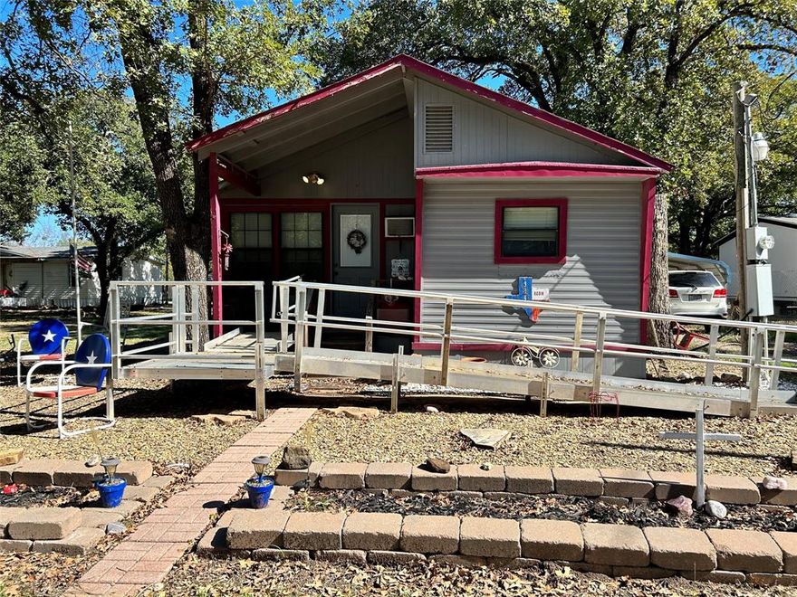 Take a look at this 2 bedroom 1 bathroom home located in Hawk Cove! Vaulted ceilings make this home feel so open. It has been added on in 2006 with a beautiful front porch that is completely enclosed serves as an additional living room. There was also a back utility room with a pantry added in the back along with the roof being redone in 2006. Central heat and air except in the added on front porch but add a window unit for those hot Texas days and you will be cool in no time. Minutes from the lake this open concept is a steal. The two sheds will house all your lawn items with extra storage. The ramp is staying as well. Will not be able to be financed as it was a travel trailer that was added on. Seller is selling as is and will not make any repairs. All information contained herein deemed reliable but not guaranteed. Buyer and buyer's agent to verify all info including dimensions and schools. Broker, brokerage, and listing agent are not responsible for any inaccuracies.