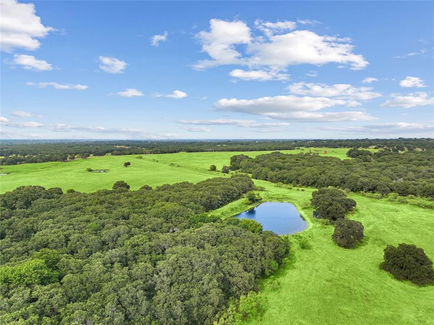 Discover a stunning **487-acre ranch** just **30 minutes west of Fort Worth**. This property boasts **10 ponds**, **2 creeks**, and a reliable **water well**, providing ample water for livestock and wildlife. Fully **fenced and cross-fenced**, it’s ideal for cattle management and features **rolling topography** with a **120-foot elevation change**, offering breathtaking views. The land includes productive **coastal fields**, perfect for grazing and farming, scattered oaks throughout.  Key improvements include **two sets of cattle pens**, a **30'x70' equipment barn**, and a **50'x22' covered barn** for storage. With significant **road frontage**, this ranch offers easy access and visibility for potential development. Whether you’re seeking a thriving agricultural operation or a tranquil retreat, this versatile property presents an exceptional opportunity in a prime location. Don’t miss your chance to own this Texas paradise, where natural beauty and agricultural potential meet!
