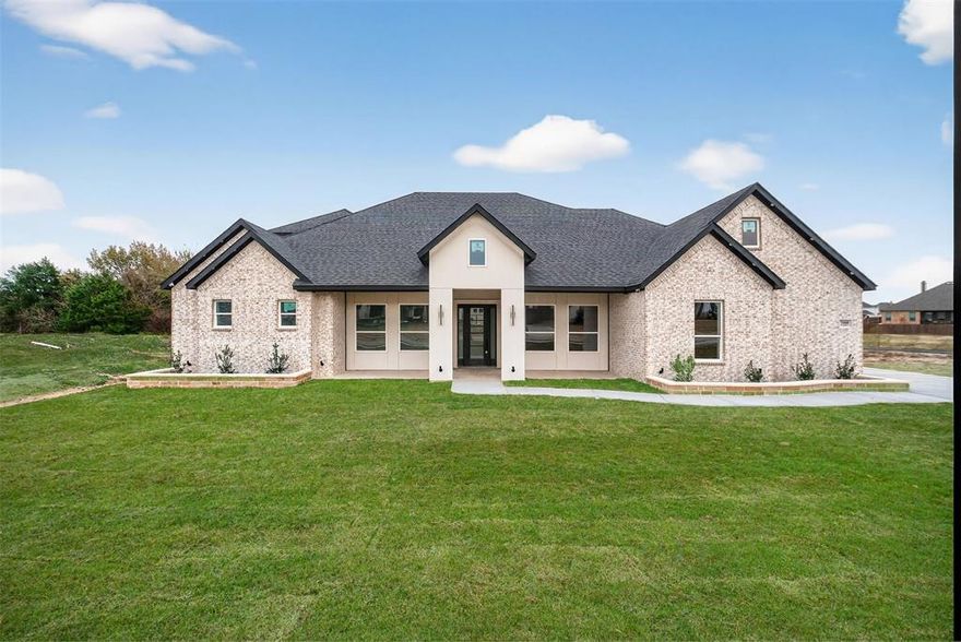 Stunning new custom construction located in the highly desirable Ovilla, TX community. This exceptional home offers approximately 4,400 square feet of thoughtfully designed living space, situated on an oversized corner lot with no neighbor on one side and peaceful pond views nearby, providing privacy and a serene setting.

The home features 4 bedrooms, 4 full bathrooms, a private office, and a dedicated theater room. Designed with modern living in mind, the open floor plan showcases soaring high ceilings, abundant natural light, and high-end custom finishes throughout.

The gourmet kitchen is ideal for entertaining and daily living, featuring custom cabinetry, premium finishes, and a seamless flow into the main living areas. The primary suite is a true retreat, offering generous space, a spa-like bathroom with an oversized custom shower and soaking tub, dual vanities, and a large walk-in closet with direct access to the laundry room for added convenience.

All secondary bedrooms are well-sized, and each bathroom includes custom design elements and upscale finishes. The theater room provides the perfect space for movie nights, while the private office is ideal for working from home.

Located in Ellis County, this home benefits from a quiet, established neighborhood setting and highly rated schools, while still offering convenient access to nearby shopping, dining, and major highways.

A rare opportunity to own a luxury custom home with exceptional craftsmanship, privacy, and a prime Ovilla location.