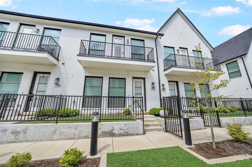 Luxury living meets a modern urban lifestyle in this stunning townhome located in the highly sought-after Main 7 community in the heart of Arlington. From top to bottom, this home is filled with designer upgrades that surpass even newer builds, offering exceptional style and sophistication throughout. Natural light pours in through oversized windows, highlighting the open-concept layout and beautiful wood flooring throughout, including hardwood floors in the downstairs bedrooms.
The chef’s kitchen is a true showpiece, featuring quartz countertops, a striking marble backsplash, designer vent hood, and top-of-the-line Bertazzoni appliances. A large center island anchors the space, seamlessly connecting to the spacious living and dining areas, which open to a private balcony—perfect for indoor-outdoor living. The home offers two balconies, including an impressive rooftop balcony ideal for entertaining or enjoying city views.
Upstairs, the private primary suite provides a serene retreat with expansive windows and a spa-like ensuite bathroom complete with a frameless walk-in shower, large vanity, and designer finishes. Additional features include a WiFi-enabled garage door opener, electric car charger in the private two-car garage, a laundry room with added shelving, and a fenced front yard.
Enjoy the convenience of reserved street parking, gated community access, and an unbeatable location just minutes from AT&T Stadium, Globe Life Field, and premier dining and shopping. This exceptional townhome delivers the perfect blend of luxury, functionality, and vibrant city living.