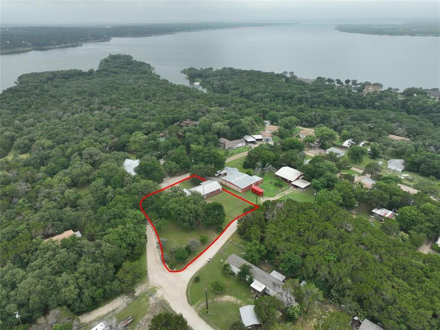 Recently improved price, Fiber optics is now available on this corner lot on Lake Whitney... so you can work from home with no hiccups! The home has been recently renovated with new ceilings and updated interiors. Unrestricted area perfect for investment rental. Retail, gym, schools, pharmacies, medical clinic and public library less than 20 minutes away. Tucked on a quiet corner lot just minutes from beautiful Lake Whitney, this updated two-bedroom home makes a comfortable retreat with room to spread out. Inside, you’ll find fresh finishes including modern flooring, and granite countertops that give the kitchen a polished feel. A newly finished bedroom and a utility room add extra function and everyday convenience. The property sits on roughly three-quarters of an acre shaded by mature trees and covered in established St. Augustine grass. There’s plenty of space for parking or projects, with three separate RV hookups (one on a concrete pad), a detached garage, and an RV-height carport ready for lake toys or extra vehicles. The roof is less than five years old, and the HVAC system is under eight, giving you confidence in the big-ticket updates. No HOA restrictions, this spot offers freedom and flexibility—ideal for a full-time home, weekend getaway, or park your families RV's.  Parks and hiking less than 1.5 miles away along with public boat docks, picnic areas, and a lakeside pavilion, camping. 
Set within a friendly lakeside area known for its relaxed pace and outdoor charm, this home keeps you close to the water while staying convenient to town. Roughly an hour’s drive south to Waco and about the same north to Fort Worth, you can enjoy a quiet escape without losing access to everything you need.