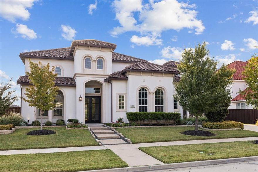 This Stunning East-facing Toll Brothers home offers a perfect blend of Mediterranean charm and modern luxury. The moment you step inside, you're greeted by a soaring double-height ceiling & a sweeping curved staircase w-wrought iron balusters—a dramatic & elegant first impression. Rich hardwoods flow throughout the entry &  into the main living spaces, enhancing the sense of warmth and sophistication. The Living rm is bright & airy w-soaring ceilings, sleek fireplace, built-ins & expansive windows that flood the room w-natural light. This kitchen is a showstopper w-white cabinetry, quartz island, built-in fridge, ice maker, double oven & pendant lighting. The luxurious primary suite offers a peaceful retreat w-sitting area and a spa-inspired ensuite bath complete w-a freestanding soaking tub, glass-enclosed shower, dual vanities & 2 closets. Upstairs offers a Game rm, Media, & 3 lrg beds w-ensuites. Step outside to your private backyard oasis, where a covered patio w-ceiling fan overlooks a sparkling pool & spa. Lush landscaping and a fenced yard provide beauty and privacy, while the outdoor living space is perfect for relaxing or hosting gatherings year-round. This home truly has it all—style, functionality, and an unbeatable outdoor lifestyle. 4 car garage! Neighborhood has clubhouse, state-of-the-art fitness facility, fishing pond, walking trails, 2 pools, splash pad, Bocce ball, Volleyball, Texas backyard BBQ area, playgrounds & more! Get to know your neighbors in this active community that hosts many monthly events including movies and concerts in the park, food trucks, sunrise yoga, holiday events, scavenger hunts, and more! This is more than a neighborhood, this is a LIFESTYLE! HOA dues include front yard maintenance and ADT security system! This prime location is minutes from DNT, Hwy 121, Hidden Cove Marina featuring bike trails, kayaking, BBQ, cabins, boating, basketball, volleyball. Close to restaurants, shopping, Grandscape, The Star & Shops at Legacy.