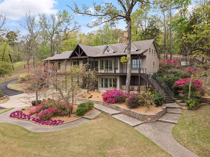 Discover unparalleled luxury in this exquisite Lake Cypress Springs gated estate. Perched on almost 3.5 waterfront acres & adorned by lush landscaping, paved walkways, resort-style amenities & breathtaking views, this approximately 4,300 sqft home offers an idyllic retreat for those seeking tranquility & recreation. Step inside to find a spacious and airy interior, designed to maximize both comfort & lakeside entertainment. The great room features a grand fireplace, vaulted ceilings & windows that span the back wall & bathe the kitchen, living & dining areas with warm natural light. Relax & unwind in the luxurious master suite, complete with a spa-like ensuite bathroom, walk-in closet & a private screened-in porch overlooking the water. With over 400ft of retained water frontage, ensuring uninterrupted views of the glistening lake, spend your days swimming, boating, fishing, or just hanging out on your like-no-other boat house. Built for year round enjoyment, the covered and uncovered lounge areas, grill with granite counter, 2 boat lifts, & a jet ski lift make sunny days on the water a breeze, while the 400 sqft heated & cooled bonus room with wall to wall windows offers a cozy & immersive refuge from the elements. The in ground oasis is truly a sight to behold. The upper level boasts an oversized hot tub that spans the length of the pool below. A diving board, fountains, sprays, splash decks, ambient lighting & multiple fire features create a fun magical ambiance enhanced by breathtaking views of the entire property and across the lake. This extraordinary lakefront estate offers the perfect blend of elegance, comfort, & natural beauty. Don't miss this opportunity to experience the ultimate in lakeside living.