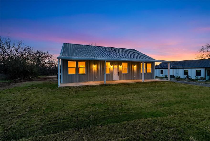 Welcome to 180 Cimmarron Trail in beautiful Runaway Bay, Texas — a brand-new custom home designed for comfort, efficiency, and modern living. This thoughtfully crafted 3-bedroom, 2-bath residence spans 1,620 sq. ft. and features inviting 8' x 45' covered porches on both the front and back, perfect for morning coffee or evening relaxation while enjoying the peaceful surroundings. Step inside to an open-concept living area highlighted by an electric fireplace and large windows that fill the space with natural light. The kitchen is the heart of the home, offering custom cabinetry, a large island with seating, and plenty of storage and workspace for cooking and entertaining. Just off the kitchen, the utility room provides convenience with washer and dryer connections, a pantry, and room for a stand-up freezer. The primary suite offers a private retreat featuring a spacious walk-in closet, an oversized 6' soaking tub, and a beautiful walk-in shower. Secondary bedrooms are generously sized and share a well-appointed hall bath. Built with energy efficiency in mind, this home includes foam insulation, vinyl windows, a two-stage 3-ton HVAC system, and a smart energy-efficient hot water heater, helping keep utility costs low and comfort high year-round. Located in the desirable community of Runaway Bay, you’ll enjoy access to Lake Bridgeport, parks, and all the outdoor recreation this lake community has to offer. Whether you’re looking for a full-time residence or a peaceful retreat, this home combines quality craftsmanship, energy efficiency, and relaxed Texas living all in one. Come see why 180 Cimmarron Trail is the perfect place to call home!