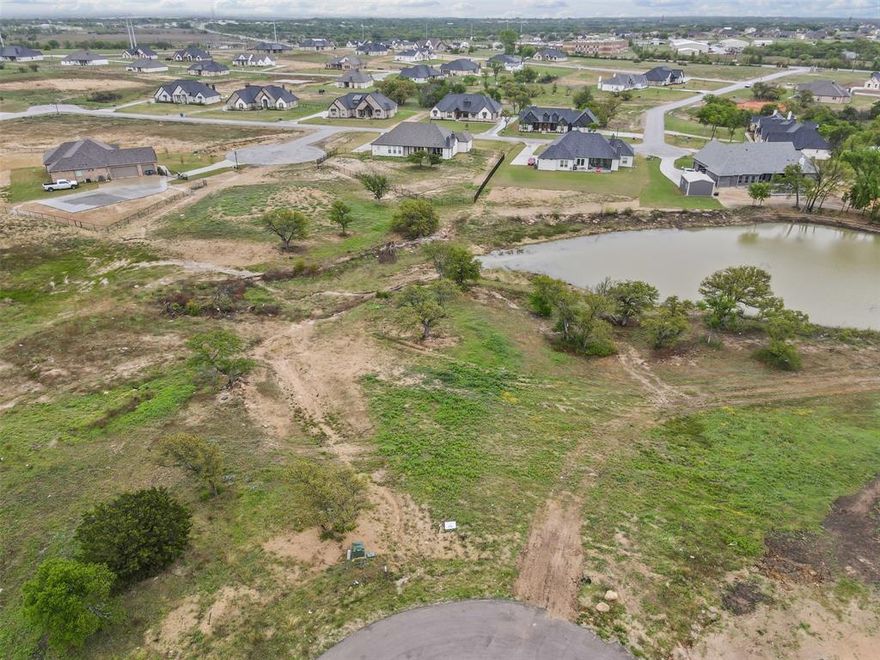 Discover the perfect spot to bring your dream home to life in the desirable Calhoun Acres subdivision in Azle, TX. This spacious 1.25-acre lot on a cul-de-sac, is cleared and ready to build, offering a beautiful and peaceful setting with a serene pond view right in your backyard. Located in the highly-rated Azle ISD, this property combines the charm of country living with the convenience of nearby city amenities. Enjoy the open space, scenic surroundings, and the freedom to create a custom home, pool, and shop tailored to your lifestyle. For commuters, this is located about twenty minutes from Ft. Worth and Weatherford.