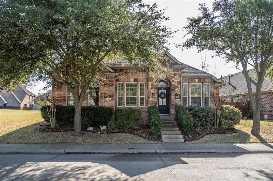 This beautifully appointed one-story brick-and-stone home makes a striking first impression, offering an immediate wow factor from the moment you arrive. A stunning foyer with rich wood flooring warmly welcomes you into this charming 3-bedroom, 2-bath residence, setting the stage for the quality and comfort found throughout. Exceptional curb appeal is paired with a highly desirable location overlooking a large neighborhood park and playground, with adjacent green space that creates a refreshing sense of openness and privacy. Inside, wide-plank wood floors, updated designer lighting, and fresh, contemporary paint tones enhance the home’s bright, inviting atmosphere. The dining area is perfectly suited for entertaining, while the adjacent playroom or flex space—complete with French doors—easily serves as a private study or home office. The spacious family room is the heart of the home, featuring a dramatic floor-to-ceiling stone fireplace that adds warmth, character, and visual impact. Thoughtfully designed, meticulously maintained, and ideally located, this home delivers a balanced blend of style, functionality, and everyday livability—perfect for both relaxed living and memorable gatherings.