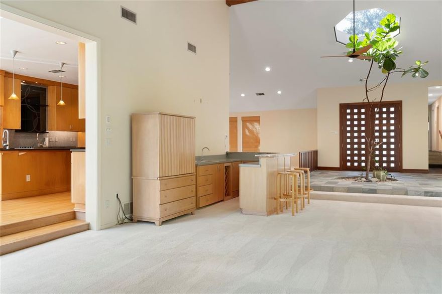 A midcentury modern 4-bedroom, 3 ½-bath 1970s home on a hard to find .62-acre lot that is priced under $1.5 million. Dramatic soaring ceiling with wood beams, a wood-gas stone fireplace and a bank of windows overlook the pool, lighted gazebo, three patios, bocce ball court, built-in outdoor grill, pool and forrested creek lot.  Sound system linked to inside and outside.  Many improvements have been made to the home including three skylights in the kitchen and a skylight over the live tree in the entrance hall.  You will find a whole-house generator, new pool equipment, new water heaters, new hospital grade air filtration systems, new garage door (insulated), Tesla charger, new AC units, gutters with leaf covers and quality lighting.  Two master bathrooms and an attic large enough to add another room.  A ginkgo tree and two magnolia trees add to the landscaped property. The garage has a built-in workbench with drawers and cabinets and a separate closet.  As with many 50-year-old modern homes, you may choose to refresh the design or revel in the dramatic spaces and enjoy the many fine finishes.