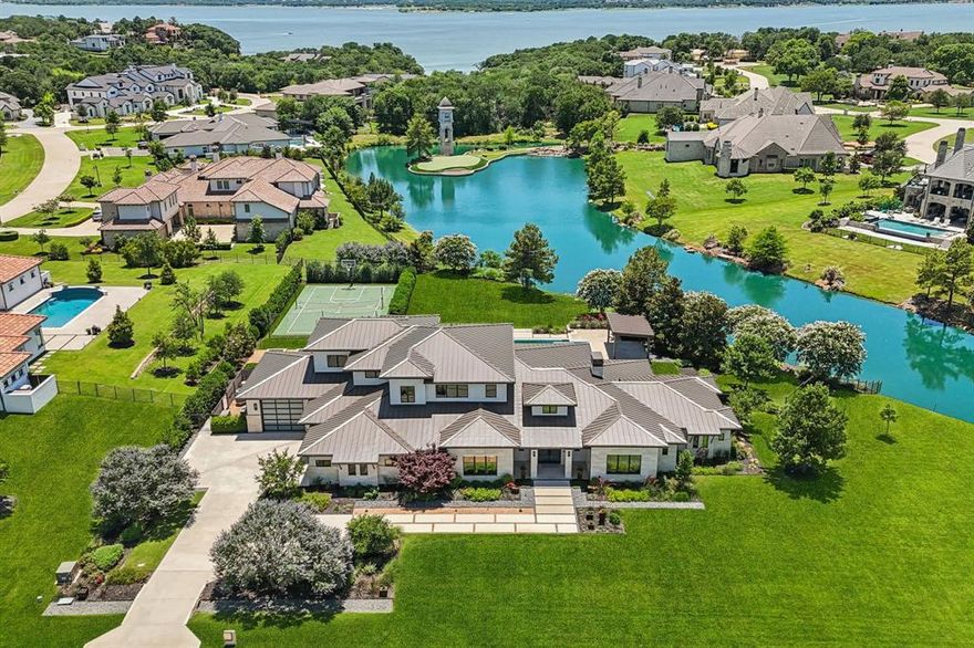 Welcome Home to this stunning modern, Luxury estate! 2005 La Salle is located in the prestigious gated and guarded community - The Enclave at Chateau Du Lac. This Calais Custom Home reflects inspiration from the Austin Area with a Hill Country Contemporary architectural design. This thoughtfully designed estate delivers breathtaking views of the pond, large backyard and infinity edge pool! All windows are UV coated for energy efficiency with motorized shades. Continuous wide plank Duchateau floors warm up the contemporary living space making it comfortable yet elevated. The wood beamed ceiling and linear limestone fireplace add to the ambiance of the space. The Kitchen will delight every chef with an island that provides a built-in table with marble waterfall edge, quartz countertops, commercial grade Wolf appliances, built-in ice maker & Sub Zero refrigerator. The Prep kitchen with abundant storage and separate freezer will also make entertaining a breeze. The Primary Retreat does not disappoint with breathtaking outdoor views plus a private covered patio, fireplace with sitting area, ensuite spa bathroom with oversized soaking tub, floating vanities with quartz countertops and a spacious closet with island for storage. Downstairs you will also find a Guest Bedroom with sitting area+ ensuite bath, Executive Office with entrance to the patio, another Living-Flex area that could be used as a den or 2nd office, plus a Media Room with screen and projector -all media equipment and Elan Home System to convey! Upstairs boasts a very large Game Room, 2 additional secondary bedrooms with ensuite baths and an expansive storage closet. The 3 car oversized garage has one bay large enough to store a large boat. Outdoor highlights include 3 limestone encased, raised & irrigated garden beds, built-in gas grill, Tennis Court, linear outdoor fireplace with built-in sitting area, loads of covered outdoor living space with fireplace & Whole Home Water Filtration System with UV light.