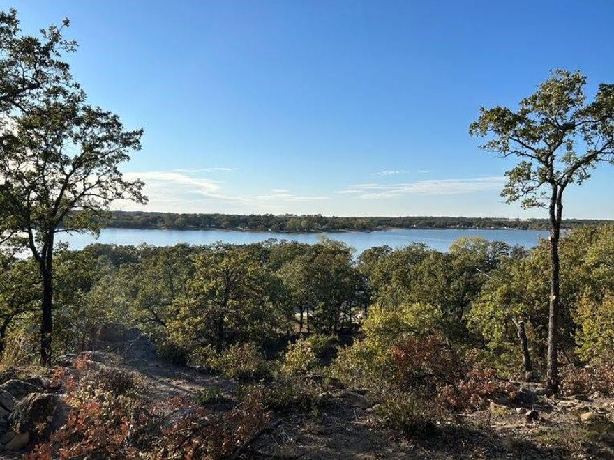 Beautiful undeveloped build site with breathtaking views of Lake Nocona in North Texas Hill Country! Property is 2 lots combined for a total of .516 of an acre with beautiful mature oak trees.  Club House and pool are being completely Remodeled for the community and Golf course is getting lots of upgrades. Owner has many lots available to choose from, please contact listing agent for details. Lots are surrounded by the tranquility of nature as you will often see deer all around the property. Nocona Hills offers a 24-hour guarded gate community with access to two private lakes (one listed as top 5 Bass fishing in Texas)a community boat ramp and dock, as well as an 18-hole golf course with driving range, an airstrip, campgrounds with RV sites, and more. Utilities include co-op water and electric already at street. Fiber optic high speed internet is also available. Nearby surroundings include historic downtown Nocona, a winery, brewery and just a short drive to Saint Jo, Muenster and popular Casinos. Come see Awesome Community