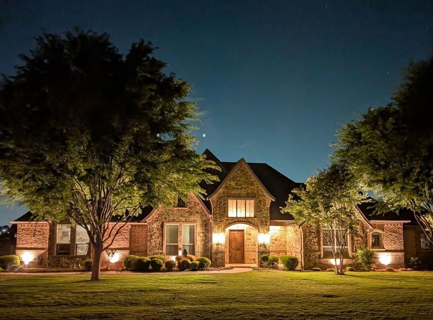 Stunning custom-built home in DC Ranch, one of Celina’s most desirable communities, known for its one-acre homesites, serene setting, and strong neighborhood appeal. Situated on a beautifully landscaped 1+ acre lot, this meticulously maintained 4-bedroom, 3.5-bath residence offers exceptional craftsmanship, thoughtful upgrades, and seamless indoor-outdoor living. The open-concept floor plan features spacious living and dining areas complemented by custom finishes throughout. The chef’s kitchen is equipped with granite countertops and updated appliances, flowing effortlessly into the main living space—ideal for both everyday living and entertaining. Recent mechanical improvements include two HVAC systems, professionally cleaned air ducts, new ductwork above primary room for added efficiency, and UV antibacterial air purification systems for enhanced indoor air quality. The primary suite has been tastefully updated with new tile flooring, a fully remodeled custom closet, and upgraded lighting. Additional highlights include built-in cabinetry in the living room, a generously sized laundry room with granite counters, utility sink, and space for a freezer, along with abundant storage throughout. The oversized three-car garage offers added functionality and access to a massive walk-in attic.
Designed for year-round enjoyment, the backyard retreat features a heated pool with cabanas, a large covered patio with a fireplace, automatic awnings, and a custom privacy screen. Three Big Fans provide added comfort on the patio and in the garage. The fully fenced property includes mature trees and an additional fenced area ideal for a garden or pets. Conveniently located near major retail destinations including Walmart and Costco, and just minutes from charming downtown Celina with its local dining and community events. This home offers the perfect balance of peaceful acreage living and easy access to modern conveniences.
