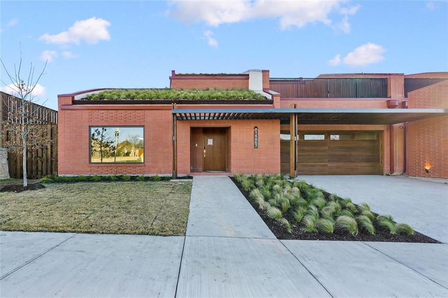 Contemporary architecture meets sustainable, nature-driven design in this newly constructed residence within Tapestry, a design-forward community shaped by intention, and craftsmanship. The home makes a striking first impression with red terracotta brick & a signature green roof - an architectural statement that blends form and sustainability. Inside, a sculptural curved ceiling begins at the entry and rises through both levels, creating a sense of movement & continuity throughout the home. Tile and wood flooring and abundant natural light define the interior experience. Open-concept living spaces are designed for seamless indoor–outdoor living, with expansive sliding glass doors connecting the main living areas & bedrooms directly to the yard and terraces. The kitchen anchors the home with custom cabinetry, quartz countertops, a large island with breakfast bar, floating shelving, & premium appliances including a Sub-Zero refrigerator and Wolf double ovens and gas cooktop. A walk-in pantry & utility room with cabinetry, counter space, and sink. Upstairs, a spacious game room with built-in shelving and a contemporary window seat opens to a large grassy terrace. The primary suite offers tall ceilings, built-in storage, and a private terrace. Its spa-inspired bath features a dual-sink vanity, sunken soaking tub, built-in money tree, glass-enclosed shower, and a generous walk-in closet with custom storage. Additional bedrooms include custom walk-in closets & access to en-suite or hall baths. Outdoor living is further enhanced by an uncovered side courtyard and a covered backyard patio, while a three-car tandem garage completes the home. Standard features include green roof construction, geothermal heating and cooling, and solar integration. Tapestry’s end-to-end design ensures cohesive architecture and interiors, with optional furnishing packages available. Located within Frisco ISD, planned community amenities include a clubhouse, pool, fitness center, etc.