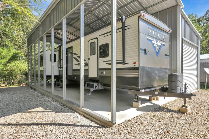 Escape to lake living at its finest on the famous Lake Fork with this immaculate 2021 38 ft Puma travel trailer featuring 4 slide-outs for maximum space and comfort. Set on a 30x40 concrete pad, this property combines the perfect blend of home-style living and outdoor retreat. Located in a gated community, this waterfront lot is surrounded by mature trees, wildlife and just a short walk to the lake from your backyard. Inside the homes spacious open layout you will find comfortable seating with 2 recliners, a pull out couch, a kitchen island, fireplace, abundant cabinets, SS appliances, never used stove-oven and stackable WD for convenience designed for full time living or weekend getaway.  
This property is turn-key, low maintenance, move in ready and perfect for enjoying lake life in comfort.
Holiday Village offers something for everyone, salt water pool, playgrounds, basketball courts, and putt putt golf. Stocked ponds, 2 boat ramps, onsite restaurant, monthly events, bingo, karaoke and much more. 
Family friendly neighborhood that is golf cart and ATV friendly. 
Mandatory HOA fee is $52 water and sewer are $65 monthly plus usage.  
Plenty of room for parking and a 14X30 garage for boat storage.