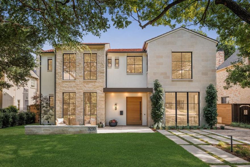 Introducing an exceptional new construction in University Park. Thoughtfully designed and impeccably executed, this striking residence complete with a pool and three-car garage seamlessly blends architectural elegance with modern luxury. Showcasing a timeless palette of stone and stucco beneath a clay tile roof, the home exudes refined sophistication and resort-style living. Built by Shaw Building Group with interiors by Swoon Interiors, the home offers a meticulously curated floor plan, including a first-floor ensuite bedroom ideal for use as a guest suite, private study, or fitness room. A custom oversized pivot door makes a bold first impression, opening into the home featuring a living space with soaring 12-foot ceilings, smooth rift-cut millwork, a designer-crafted bar and a striking floating staircase framed by a sleek glass railing. Designed for effortless entertaining, the chef’s kitchen with custom cabinetry, Calacatta Vagli marble countertops and backsplash, double dishwashers, Wolf and Sub-Zero appliances and anchored by a hidden fully equipped scullery. Sliding glass doors from both the great room and dining nook create a seamless indoor-outdoor transition. Step into the serene backyard retreat, complete with a sparkling pool, limestone patio, fireplace, retractable screens, and built-in heaters offering year-round comfort and alfresco dining. Upstairs, the primary suite serves as a private sanctuary, featuring dramatic vaulted ceilings with millwork, a cozy fireplace, a coffee bar, dual vanities with Calacatta marble counters, marble flooring, and dual commodes and two illuminated walk-in closets. Additional ensuite bedrooms, a versatile sound insulated game room, and a double laundry room with dog wash complete the upper level. Located within Highland Park ISD and just steps from Boone Elementary, this home offers an unparalleled blend of style, comfort, and convenience in one of Dallas’s most prestigious neighborhoods.