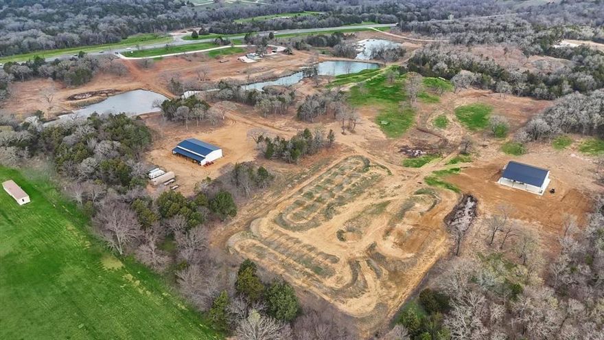 Presenting an exquisite ranch estate with 65 sprawling acres of prime topography, approximately 1,300 ft of highway frontage, a modern, newly constructed 3,400 sq ft barndominium and 3,200 sq ft shop, 2 expansive stock ponds that run the width of the property for pristine views and landscape, a motocross track professionally built by Blake Wharton, a partially wooded creek with a variety of trails for recreational use, and more. The home is set to be completed by the end of summer and will boast a modern feel with an indoor outdoor living experience. The large, 40X80 shop features 4 overhead doors, with a slab engineered for heavy duty equipment and an overhang for additional storage. The property has many additional pad sites, some of which already have dirt work completed, multiple electric boxes, septic tanks and water hook ups, making it easy for someone to add a barn, second home, etc. Located conveniently off HWY 377 the property is a short drive to Lake Texoma and towns.