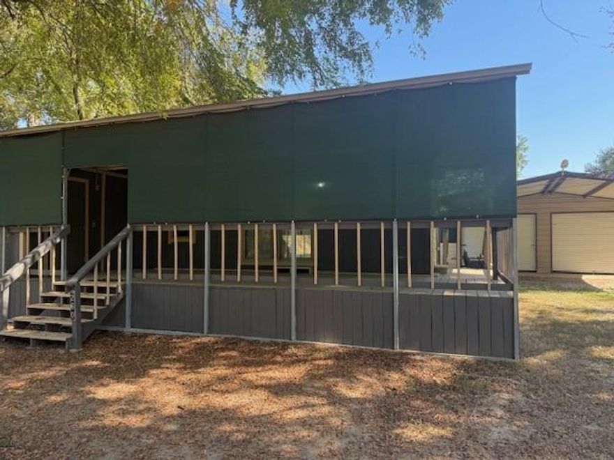 Perfect little lake house for you!! This one comes with a large shop equiped with electric and water, two car carport, circle drive, one bedroom tiny home, large front and side deck, seperate laundry room on front porch and space to add anything else you might need. Tiny home has living kitchen space, seperate bedroom with built in closet with storage and seperate bath with shower. Neighborhood has access to boat ramp, community swimming pool and clubhouse. You won't want to miss this one!