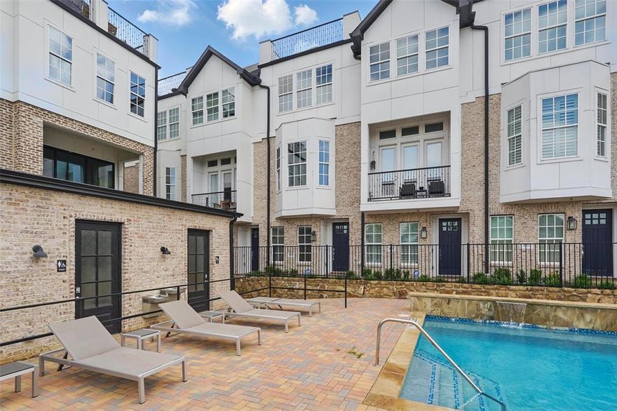 Stylish 2-bedroom townhome with a rooftop deck and pool views in an unbeatable location near the Medical District. Designed for easy, low-maintenance living, this home blends modern finishes with an open and airy layout featuring soaring ceilings, rich wood flooring, and abundant natural light throughout. The sleek kitchen is equipped with stainless steel appliances, a gas range, oversized island, walk-in pantry, and beverage refrigerator—ideal for both everyday living and entertaining. A convenient half bath completes the main level. Upstairs, both bedrooms offer walk-in closets and private ensuite baths with designer finishes. The spacious primary suite includes electric shades, dual sinks, and a frameless glass shower. On the top floor, enjoy a generous rooftop deck overlooking the community pool, creating the perfect outdoor social space. Attached tandem garage with additional storage space. Prime location with quick access to major highways, airports, shopping, dining, and the Medical District.