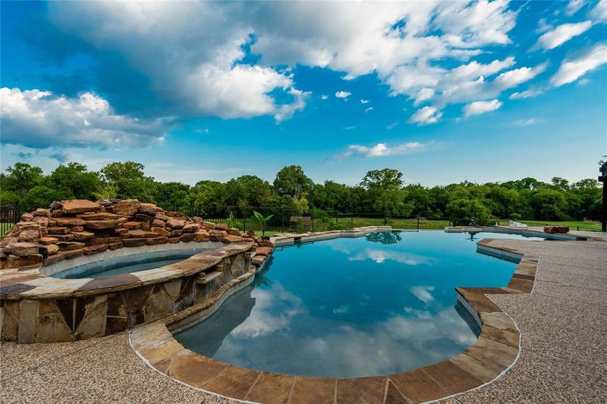 Greeted by a gated entry and winding drive, this 11-acre estate blends timeless elegance with wide-open Texas skies. Perfectly positioned on a coveted corner lot, within walking distance of Breckinridge Park and Firewheel Golf Park, it offers the rare combination of privacy, beauty, and convenience.

The property has grown in both size and stature in recent years—most notably with the purchase and addition of 2 acres along Campbell Road, creating a more expansive and versatile estate. Alongside this, the home has undergone extensive remodeling, including a reimagined first floor, a stunning new kitchen, and a beautifully updated pool area that feels more like a boutique resort than a backyard.

Inside, sunlight pours through remodeled windows, filling spaces designed for both comfort and connection. The oversized downstairs primary suite is a retreat of its own, while thoughtful touches like an office, expanded utility room, bonus storage, and even a built-in dog spa make everyday living seamless.

The new kitchen—with custom cabinetry, a marble-textured backsplash, premium appliances, and walls opened to enhance flow—anchors the heart of the home. Living and dining spaces center around a striking second fireplace, while upstairs offers a media room, an additional family room, and a balcony overlooking the landscape.

Step outside to enjoy the 10-foot infinity-edge pool, outdoor kitchen, and cabana-style lounge perfect for entertaining under the stars. Wander to the pond for fishing or quiet reflection, or watch children (or the young at heart) explore the whimsical treehouse. Towering mature trees and open fields invite horseback riding, gardening, or simply savoring the peace.

Completing the estate is a 3-car garage with storm shelter, ample parking, and an additional 2,600± sq ft building ready to become guest quarters, a workshop, or even a private venue.

Here, every sunrise and sunset feels like it was painted just for you.