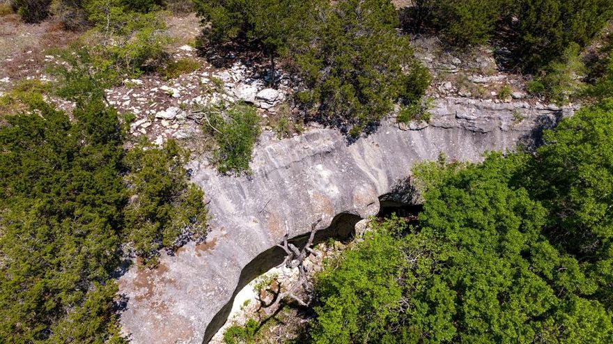 This ranch offers one of the highest points in Hamilton County. When you enter the ranch an historic windmill greets you, wind up the mountain to the ranch house that sits 150' from the base of the mountaintop. The house has been completely remodeled and is very open, airy and modern. Main house 2,000 SF, 2 bedrooms & 2.5 baths + Bunkhouse is 1200 SF. This ranch is perfect for hunting hog, turkey, deer, varmint and dove! The property ranges from 1200' to 1360'; the mountaintop provides desirable elevation change with amazing views of the surrounding counties. Roughly 80% of the property is heavily wooded with a variety of oaks, elm and cedar, the remaining 20% is native pasture. New roads, water tank storage and many improvements have been made recently to the ranch.  Water: 800' deep + old windmill well; both water wells have brand new holding tanks and have been updated in 2021. Beautiful property in a great location just outside of Cranfills Gap and Hico, Texas.