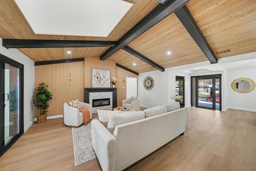 Experience elevated living in this exceptional, fully reimagined residence in Merriman Park Estates. Designed by Together Design and Build, this 2,701 SF home sits on a 0.2-acre lot and features 4 bedrooms, an office, 3 bathrooms, and a 2-car garage, offering a refined balance of elegance and functionality. From the moment you enter, you are greeted by a grand open-concept layout filled with natural light, enhanced by brand-new energy-efficient windows and clean architectural lines. The chef’s kitchen is the centerpiece of the home, designed to impress with custom white oak cabinetry, Taj Mahal quartz countertops, and a striking waterfall island. Premium stainless steel appliances, a curated breakfast nook, and seamless flow into a custom-designed laundry room with statement cabinetry create both beauty and practicality. A dry bar with an integrated wine cooler adds a layer of luxury, perfect for entertaining. The main living space exudes modern elegance, featuring custom ceiling detailing, a sleek electric fireplace with a designer tile surround, and a bold architectural feature wall with integrated LED lighting, creating a dramatic yet inviting atmosphere. The primary suite is a true sanctuary, offering dual walk-in closets and a spa-caliber wet room complete with a freestanding soaking tub and a rainfall shower wrapped in floor-to-ceiling tile. Two secondary bedrooms share a beautifully appointed Jack-and-Jill bathroom, while the fourth bedroom includes a private ensuite, ideal for guests. Throughout the home, premium flooring, designer lighting, and curated finishes elevate every space. Expansive 96” x 80” bi-fold doors open to a private backyard retreat featuring a custom-built deck, a 4-person barrel sauna, a cowboy pool, and a newly installed 8-foot stained privacy fence. Ideally located just minutes from White Rock Lake, the Dallas Arboretum, Lakewood, and Lower Greenville, with convenient access to premier dining, shopping, and major highways.