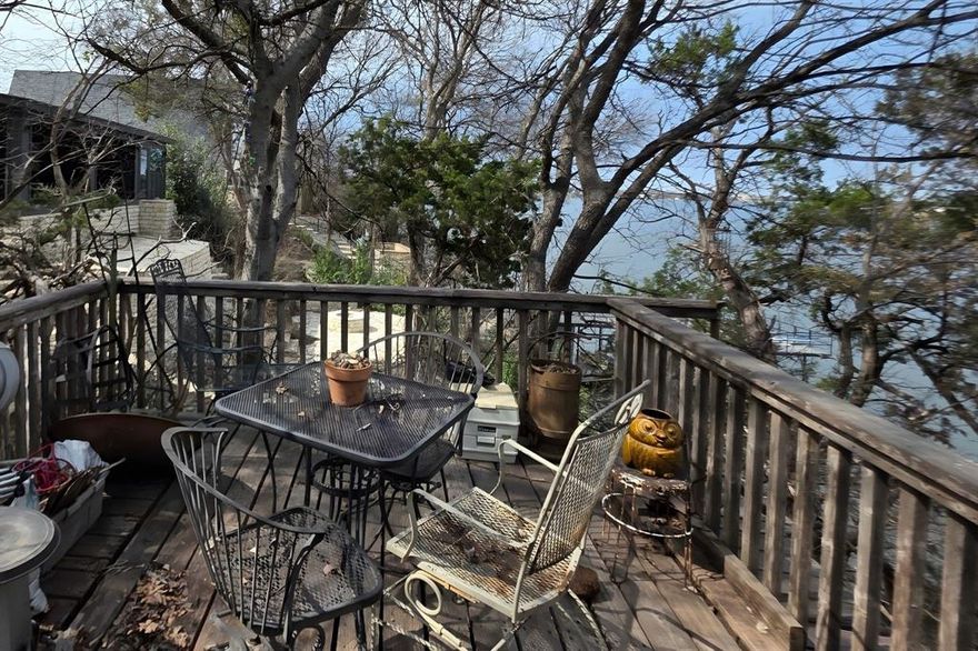 Unique opportunity to own a waterfront property on the main body of Lake Granbury. Elevated above the shoreline in a private, wooded setting, this property offers the potential for enhanced lake views with selective clearing (buyer to verify requirements).

Located within an established lake community, the heavily treed lot provides shade, privacy, natural surroundings, and redevelopment potential in a desirable lakefront location.

The cabin, originally built in 1970, offers 2 bedrooms and 1 bathroom and presents a strong opportunity for renovation, updating, or future custom construction. The home reflects deferred maintenance and will benefit from cosmetic improvements and updates, making it ideal for buyers seeking a project property, weekend retreat renovation, or long-term lake investment.

Utilities are already in place, including private water service, electricity, and an existing septic system. The home also features a metal roof replaced within the past 7 years, per seller. Property to be sold as-is. Buyers are encouraged to perform their own due diligence regarding utilities, shoreline requirements, and redevelopment potential.

A dock was previously located on the property and has been removed. Buyers may explore future shoreline improvements or potential dock installation subject to Brazos River Authority requirements and permitting , buyer to verify.

Value lies primarily in the land, location, and waterfront setting, offering an opportunity to create a personalized lakeside retreat with strong upside potential.

Showings are by appointment only with a minimum of 24-hour notice and must be coordinated through the listing agent.