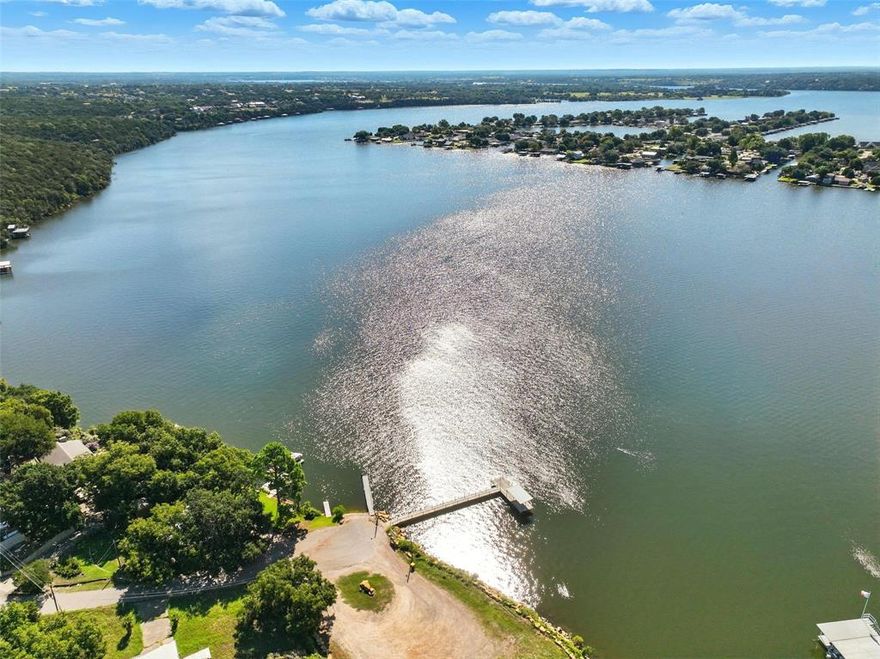 Ready to enjoy life by the Lake? This 3 bed, 2 bath with Newer Roof! Whether you are looking for an Affordable home, Vacation spot, or Investment THIS IS IT! Open Concept Floorplan with lots of storage and countertop space in the Kitchen with a Gas Range. White siding with Black shutters, Black Roof, Black gates. When you have company over you can keep your dogs separated from the main yard. Hurry and view before this one is gone! **OPTIONAL to pay $240 Year to have access to the community Pool.**