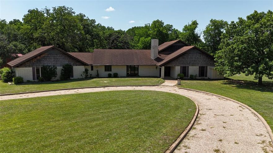 **Custom Brick Home on 25.43 Acres – 98 Highway 22 E, Hamilton, TX**

Welcome to your country retreat! This custom-built brick home, featuring a lifetime shake metal roof, offers 3,440 sq ft of comfortable living space with a 522 sq ft attached oversized garage and workshop. Built in 1971 with quality craftsmanship, this spacious 3-bedroom, 3.5-bath home boasts a large sunken living room with a cozy fireplace, vaulted beamed ceilings, and an abundance of natural light.  

The kitchen is a chef’s dream with custom cabinetry, a built-in oven and microwave, a dishwasher, and an eat-in dining area. You'll love the extra space with two utility rooms, a bonus room, and plenty of built-in storage throughout.  

An added bonus is the full-home generator powered by a propane tank, providing peace of mind with uninterrupted power whenever needed — as long as you have propane, you're covered!  

Set on 25.43 beautiful acres, the land features hardwood trees including elms, oaks, cedar, and mesquite, a picturesque wet-weather creek, and lush bottomland ideal for livestock or recreation. The property is fully fenced and cross-fenced, complete with a set of pipe working pens for livestock.  

Enjoy easy access with State Highway frontage, a pipe and curved circular driveway, a barn for UTVs or golf carts, and a storage building for all your equipment needs.  

If you're looking for a private, versatile property with a spacious custom home and prime acreage — all just minutes from town — this is the one!  

**Schedule your private showing today!**