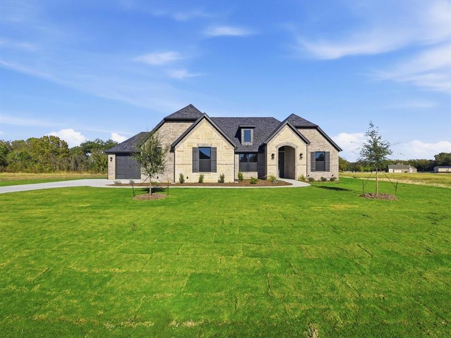 READY for move in! Discover this stunning custom home offering 2,796 sq. ft. of thoughtfully designed living space, perfectly situated on 1.536 acres. From the moment you step inside, you’ll appreciate the craftsmanship and attention to detail, beginning with the real hardwood floors, neutral colors, and decorator touches that create a warm, inviting atmosphere throughout. The heart of the home is the gourmet kitchen, complete with an expansive island, abundant counter space, and a seamless connection to the open living and dining areas—ideal for both everyday living and entertaining. Soaring vaulted ceilings and large windows fill the home with natural light, enhancing its open and airy feel. This home offers three spacious bedrooms, including a luxurious primary suite designed for relaxation. The primary retreat features a spa-like bath with a soaking tub, a stand-alone shower, and a huge walk-in closet conveniently connected to the oversized laundry room. The flexible floor plan also includes a private study and a second living area that could serve as a fourth bedroom, game room, or media room, making it easy to adapt the space to your needs. With three full bathrooms and a three-car garage, functionality meets style at every turn. Step outside and enjoy the peace and privacy of your oversized lot with a private tree-lined backyard, offering endless possibilities for outdoor living, gardening, or simply unwinding. Attractively priced, this home is the perfect blend of modern comfort, timeless design, and versatile living. Don’t miss your chance to make this exceptional property yours! $10,000 TOWARDS CLOSING COSTS OR FINANCING!!