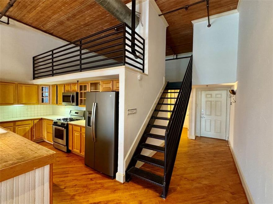 Experience true urban living in the heart of Deep Ellum with this unique loft-style condo just minutes from Downtown Dallas. Featuring soaring ceilings with exposed wood beams, industrial ductwork, and an open-concept layout, this space perfectly blends modern comfort with historic character. The spacious living area flows seamlessly into a well-appointed kitchen with ample cabinetry, stainless steel appliances, and a large island—ideal for entertaining or everyday living. Upstairs, a versatile loft overlooks the main living space, offering the perfect setup for a bedroom, office, or creative studio. The oversized bathroom features dual vanities, a soaking tub, and a striking glass block shower, adding both function and style. Enjoy skyline views from the rooftop deck, providing a private outdoor escape in one of Dallas’ most vibrant neighborhoods. Located in the heart of Deep Ellum, you’re steps away from top restaurants, live music, art galleries, and nightlife, with easy access to Downtown, Baylor, and major highways. This is city living at its finest—perfect for those seeking character, convenience, and an unbeatable location.