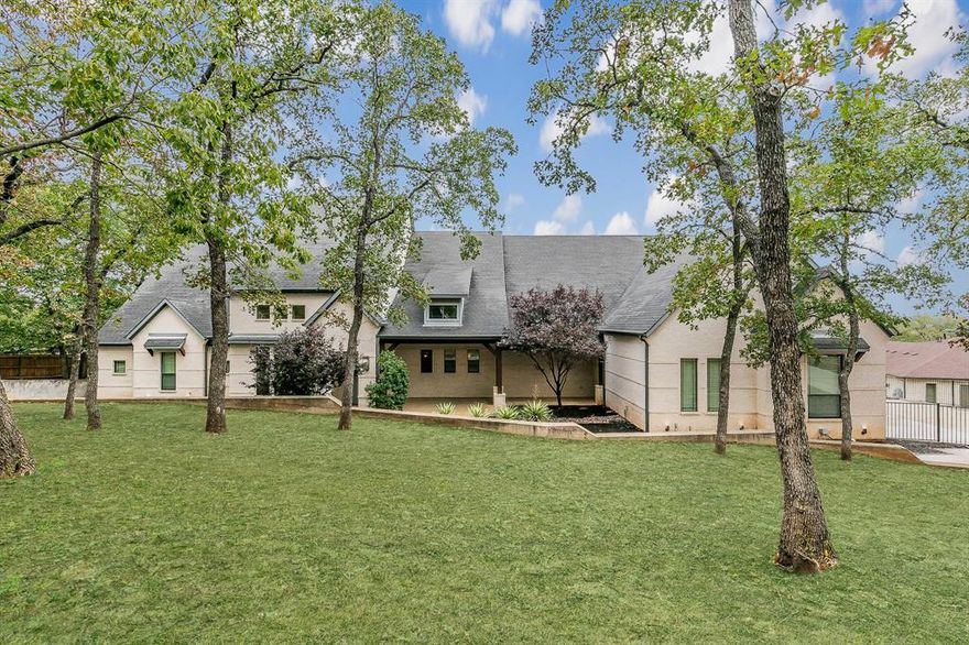 Welcome to your dream home nestled on a sprawling 1.2-acre lot, adorned with mature trees that offer both privacy and tranquility. This exquisite residence boasts a complete designer remodel  throughout the entire home.   The standout feature is the rare, fully enclosed mother-in-law suite. This private oasis includes its own living area, kitchenette, separate entry from the expansive 4-car garage, and a dedicated washer and dryer—ideal for guests or extended family living. The primary bedroom is a true retreat, occupying its own wing and featuring an additional room that can serve as a study or exercise space. Located in the desirable Southlake area of Denton County this home offers the benefit of lower property taxes and provides the flexibility to choose highly rated Southlake Carroll schools.  Experience the best of Southlake with added financial advantages and education options.  With walking distance to Marshall creek Ranch which offers equestrian and hiking trails.