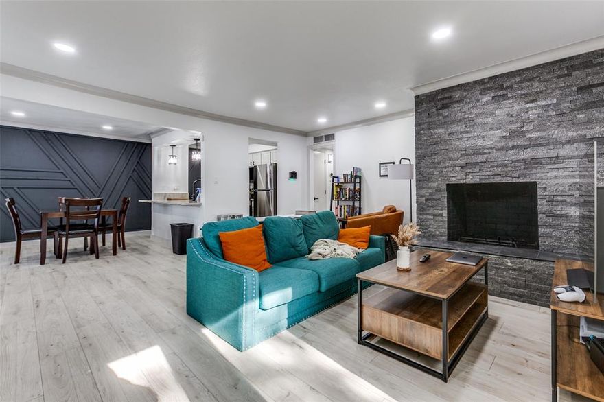 This exceptional, turnkey first-floor residence is move-in ready and features a complete, modern renovation. Located within a secured, gated community in a well-known East Dallas neighborhood, the address provides phenomenal proximity to SMU, Central Market, and Greenville Avenue. The open-concept unit showcases brand-new laminate flooring throughout (no carpet), a stylish stacked stone fireplace, and a dramatic accent wall. The kitchen is equipped with granite countertops and stainless steel appliances, complemented by new bathroom vanities and modern matte black fixtures. Enjoy rare and expansive outdoor living with three distinct private patios (front, side, and back). All amenities convey for the lease term, including a full-size washer and dryer. Community amenities elevate the lifestyle, including a sparkling pool and cabanas. The lease also includes smart features (lighting-thermostat) and two reserved, covered parking spaces. Pets are welcome. Experience stylish, low-maintenance living at this sought-after central location.