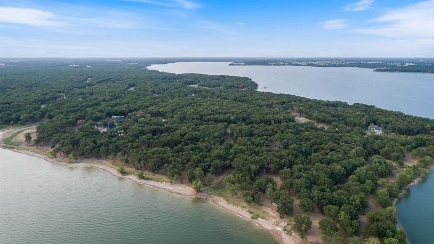 This spacious corner lot in the desirable Nautical Shores community offers the perfect opportunity to build your custom
 dream home just steps from the water — without the waterfront price tag! Situated on a quiet concrete street with
 street lamps and beautiful homes nearby, this property provides easy access to Lake Tawakoni, known for its serene
 views, great fishing, and recreational fun. This community offers a marina with a private boat ramp and if you're in
 need of your own boat slip, it is available for $500 annually. You will find families fishing off the marina and enjoying
 the lake life even without possessing a boat! Enjoy peaceful surroundings, mature trees, and the charm of a lakeside
 neighborhood while being just a short drive to town conveniences. Whether you're looking to build a weekend getaway
 or your forever home, this lot is ready to bring your vision to life! Water and electric are already available and are
 buried underground, deed restrictions in place to protect your investment, and plenty of space to make it your own.
 Bring your builder and your dreams — lake life is calling! The back of the property backs up to the Sabine River
 Authority and can be used for recreation.