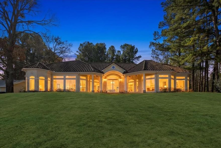 Discover the epitome of luxury living in this stunning Mediterranean style estate, situated on over 10 acres of pristine land with breathtaking sunset views over Lake Palestine. You'll enter this exclusive property through a private gate and traverse a picturesque three-quarter-mile drive lined with majestic tall pine trees, setting the stage for a truly exceptional retreat. This exquisite home features 3 bedrooms and 3 baths, a designated office with built-ins, and a versatile craft and or bonus room perfect for creative endeavors. The home's design flows beautifully, enhancing the connection to the natural surroundings while ensuring a harmonious transition between indoor and outdoor living. The covered back patio invites you to savor the tranquility of your environment. Gourmet moments await in the chef’s kitchen, boasting granite countertops, a sizeable island with a cozy sitting area, and a stunning crushed seashell chandelier that adds a touch of coastal charm. A butler's walk-in pantry provides additional storage and functionality, making entertaining effortless. Enjoy the inviting seating area designed for entertaining while overlooking the mesmerizing lake views. But the allure doesn’t end there. This estate also includes an 800-square-foot guest home, ideal for hosting family and friends, and a two-stall boathouse featuring a jet ski lift and pergola-covered seating area, perfect for sunset gatherings. With a pristine private beach, a swim platform, and an outdoor kitchen, your summer days will be filled with relaxation and enjoyment.
A dedicated shop offers ample space for RV or boat storage, while an outdoor hot tub and inviting seating area provide the ultimate outdoor retreat. Embrace the freedom of no restrictions and the luxury of this unparalleled property, where every detail has been thoughtfully designed for the ultimate lifestyle. This is more than a home; it's a secluded sanctuary where luxury meets nature, inviting you to live your dream.