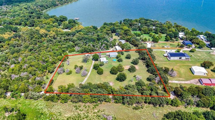 Welcome to this beautifully unique 2-bedroom, 2.5-bath barndomium that offers space, comfort, and versatility — just minutes from the lake! Perfectly suited for those who love a blend of rustic charm and modern amenities, this property has it all. Inside, you'll find rich pine floors throughout and a welcoming gas and wood-burning fireplace as the centerpiece of the living room. An elegant winding staircase leads to a loft-style upstairs bedroom and full bath, overlooking the living area — ideal for guests, teens, or a private retreat. The primary suite boasts his and hers walk-in closets and a spacious en-suite bath. Each bedroom is generously sized, and all bathrooms are thoughtfully designed for comfort and functionality. Step outside to enjoy the covered front porch, perfect for relaxing year-round. Cool off in the above ground pool and take advantage of the electric gate for added privacy and security. Equestrian or hobby farm ready, the property includes a walking pen approved for FHA, a feed shack, and ample space for animals. RV owners will appreciate the RV hookup, and guests will feel right at home in the detached garage with a fully equipped mother-in-law suite with additional 442 square foot 1 bedroom, and 1 bath with adorable porch overlooking lake which offers both comfort and privacy. Whether you're looking for a full-time residence or a weekend getaway near the lake, this property is a rare find with unmatched character and functionality. It would also be a great Airbnb. Schedule your private showing today and experience all this charming property has to offer!