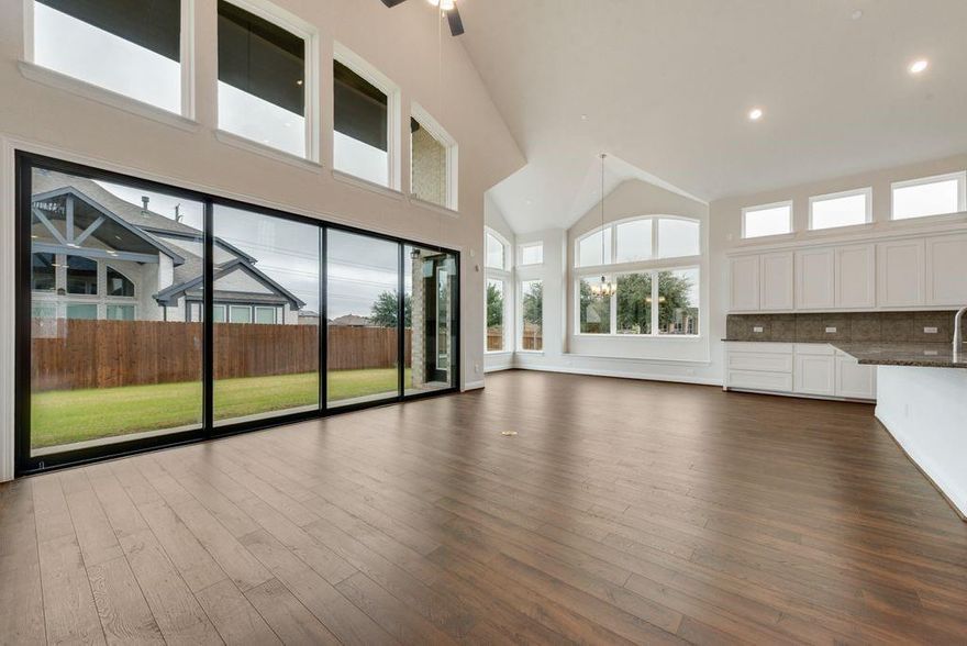 Welcome to this exceptional, newly completed residence offering modern luxury and thoughtful design in a highly sought-after location. Nestled within Mansfield ISD—with all schools just a short walk or bike ride away—this Energy Star Certified home is perfectly positioned between Dallas and Fort Worth, providing easy access to premier shopping, dining, and entertainment. Boasting impressive curb appeal, this expansive home features five spacious bedrooms, a private home office with French doors, and a downstairs guest suite, making it ideal for multigenerational living or hosting guests. The open-concept layout showcases a vaulted family room with a sleek linear fireplace and western-style sliding doors that open to a large covered back patio, perfect for entertaining. A full oak staircase with wrought iron spindles adds to the home’s elegant character, complemented by eight-foot interior doors and rocker light switches. The gourmet chef’s kitchen is equipped with Shaker-style cabinetry, slab countertops, a six-burner gas cooktop with a commercial-grade vent hood, stainless steel appliances, pots and pans drawers, a built-in trash drawer, and a spacious island. Upstairs, enjoy a media room pre-wired for projection TV, a game room with surround sound wiring, and a versatile bonus room or children’s retreat. The luxurious primary suite features a free-standing soaking tub, dual raised Marlana vanities with framed mirrors, and a frameless glass shower finished with floor-to-ceiling honeycomb tile. Built with energy efficiency in mind, this home includes R-38 insulation and a radiant barrier to ensure year-round comfort. With its modern finishes, flexible living spaces, and unbeatable location in a top-rated school district, this move-in-ready home offers the best in comfort, style, and convenience.