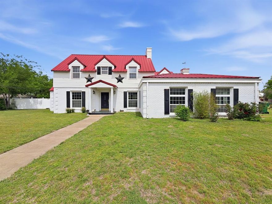 STUNNING 1928 HISTORIC ICON ON MAIN ST! Own a piece of Hamilton history with this 2,889 sq. ft. residence where timeless character meets grand proportions. This 4 bed 2 bath gem is a preservationist's dream, featuring original hardwood floors throughout and magnificent architectural details. The expansive downstairs living area is anchored by an original fireplace and illuminated by three exquisite antique chandeliers. Rare period details remain intact, including original antique doors and vintage door knobs throughout.

The floor plan offers massive room sizes and includes a functional basement for additional storage or unique utility. Move in and enjoy the historic soul as-is, or remodel to create a modern masterpiece.

The exterior is built to last with a durable metal roof and features the property’s original carriage house—ideal for a workshop or studio. Situated on a sprawling lot, the backyard is a private oasis with a full privacy fence and a large covered patio perfect for entertaining. A rare Texas treasure offering historic charm and endless potential.