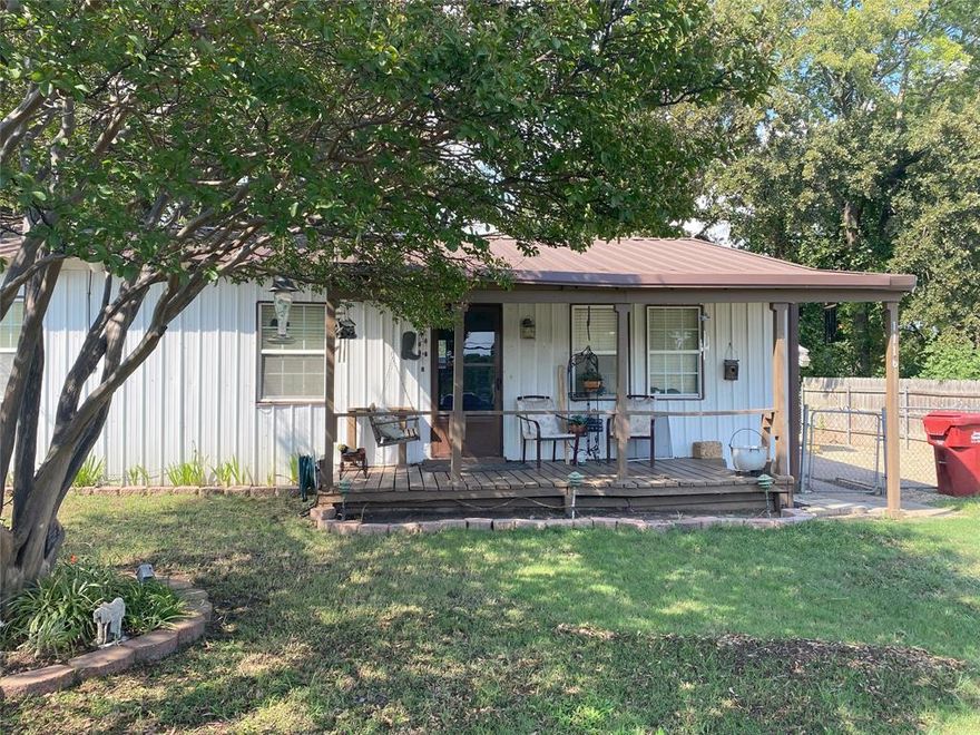 Charming 2-bedroom, 1-bath home located in front of West Tawakoni City Park, with a short walk you can enjoy Lake Tawakoni’s playground, swimming area, and boat ramps. The backyard offers an unobstructed view of the park with a partial lake view. Features a covered front porch shaded by crepe myrtles, a spacious living area, and an eat-in kitchen. While the central heat and air needs work, the seller uses window units that keep the home comfortable. The foundation is on piers, so some leveling will be required. The seller does not have a survey, so obtaining one will be the buyer's responsibility. This property also has potential for conversion into a commercial business with excellent exposure on Hwy 276—please contact the City of West Tawakoni for approval.