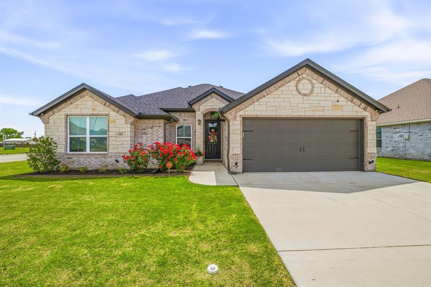 Welcome to your beautifully home nestled on a fully fenced corner lot in the highly desirable Parks of Tolar community. From the moment you arrive, the charming curb appeal, manicured landscaping, & inviting entry sets the tone for what awaits inside. Step inside to discover an open-concept layout designed for both comfort & style. Rich wood-look tile flooring flows throughout the home, offering durability with a warm, upscale feel. The spacious living room is filled with natural light & anchored by a stunning stone fireplace—perfect for cozy evenings or gathering with friends & family. The kitchen is truly the heart of the home, thoughtfully designed for both everyday living & entertaining. Featuring sleek granite countertops, crisp white cabinetry, stainless steel appliances, & ample workspace, it blends functionality with timeless elegance. The adjacent dining area & breakfast nook overlook the backyard, creating the perfect setting for morning coffee or evening meals. Retreat to the spacious owner’s suite, a private sanctuary designed for relaxation. The ensuite bathroom features dual sink granite vanities, a large walk-in shower, a separate soaking tub, & a generously sized walk-in closet—offering both luxury & practicality. Additional highlights include energy-efficient features to help keep utility costs low, newly installed window blinds for added privacy, & a home security system for peace of mind. The finished garage with epoxy flooring adds a clean, polished touch that’s both functional & visually appealing. Step outside to enjoy the covered patio—perfect for entertaining, grilling, or simply unwinding at the end of the day. The fully fenced yard provides both privacy & space to enjoy the outdoors, while recently installed gutters add to the home’s thoughtful upgrades. Located in a welcoming & growing community, this home offers the perfect blend of comfort, style, & convenience. Don’t miss your opportunity to make it yours.