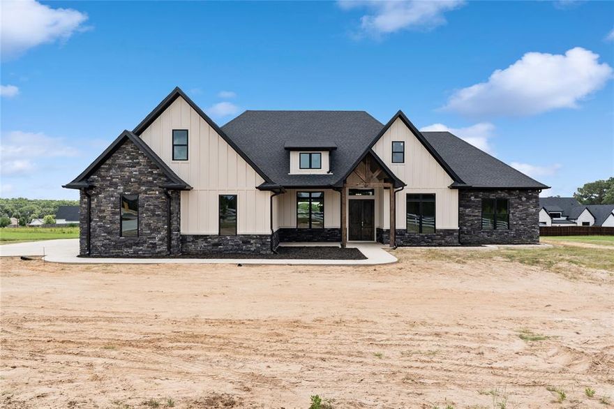 Welcome to this stunning 5-bedroom, 3.5-bath, 3-car garage home offering 3,309 square feet of beautifully crafted living space on 1.18 acres in the highly sought-after Blue Ridge Estates in Bullard—just minutes outside Tyler. Built brand new in 2025, this home showcases exceptional design, quality finishes, and thoughtful details throughout.

As you arrive, you’re greeted by a large front yard, an expansive driveway, and an inviting exterior that creates a memorable first impression. Inside, the open-concept layout immediately draws your attention, with the kitchen, living, and dining areas forming the heart of the home. The kitchen is both elegant and functional, featuring custom cabinetry, leathered countertops, unique light fixtures, abundant storage, a grand island, and a large window above the sink overlooking the backyard.

The living room impresses with soaring ceilings, a beautiful fireplace, and large windows that fill the space with natural light. Hardwood floors add warmth and character, complementing the home’s modern yet timeless style. All bedrooms are generously sized, while the bathrooms feature spacious layouts and stylish, contemporary finishes.

The primary suite feels like a private retreat, complete with detailed ceiling work, a luxurious soaking tub, a separate walk-in shower, and an oversized closet with built-in cabinetry and shelving for exceptional organization. Additional highlights include a large utility room and a functional mudroom for everyday convenience.

Upstairs, you’ll find a versatile bonus room with its own bathroom—perfect for a game room, media space, playroom, or guest suite. Step outside to enjoy the oversized covered back patio, ideal for entertaining or relaxing, along with a huge backyard offering endless possibilities for outdoor living.

With its modern craftsmanship, spacious design, and prime location, this beautiful new construction home offers the perfect blend of luxury, comfort, and space.