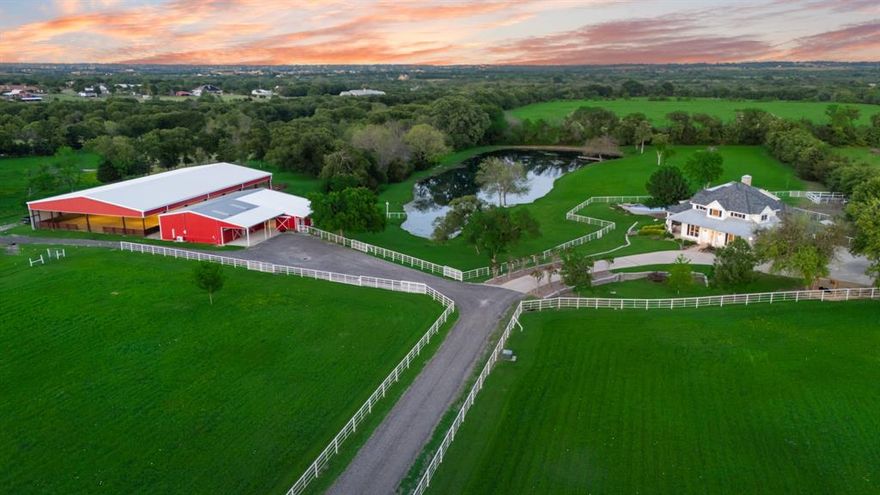 BACK ON MARKET DUE TO BUYER'S FINANCING!  Exceptional 12.34 acre Equestrian Estate with a Modern Farmhouse, Guest House and Premier Facilities.  Welcome to this beautiful gated horse ranch with 5 adjoining pastures for grazing separated by pipe fencing. This amazing horse property features a covered and lighted 80x160 single span riding arena, a fully equipped barn with 6 padded stalls, wash bay, large tack room, and an equipment barn.  At its heart stands a modern farmhouse beautifully appointed with upscale finishes throughout offering open living spaces designed for gatherings and entertaining.  The home is wrapped with windows that flood the home with natural light offering views of the serene stocked fishing pond and rolling countryside. The multiple sitting porches allow for relaxing around the diving pool or soaking in the amazing sunsets.  There is a charming 655 square foot 1 bedroom, 1 bath guest house with open kitchen and sitting area situated alongside the pond and pool area, the perfect multi-generational living opportunity.  This property delivers it all including a well-maintained chicken coop, sustainably managed and thriving bee hives.  Additionally there is a separate climate controlled workshop with a dust collection system providing ample space for tools and equipment for most any hobbyist. Whether you are raising horses, entertaining guests and family or soaking in the beauty of rural life, this ranch offers a rare combination of luxury, function and natural splendor.  A cinematic video is available upon request.