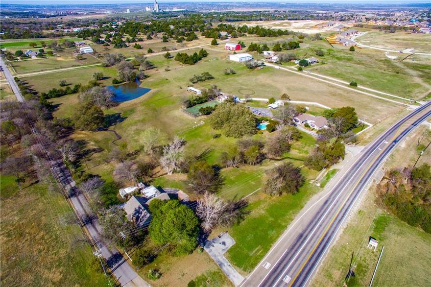 A developers dream!!! Over 13 acres of prime real estate, on the hard corner of Belmont and FM 663, directly across from Lawson Farms, and a mile from the new Kroger shopping center. Frontage on both FM 663 as well as Belmont. Comprehensive plan shows Urban light density which can include single family residential, light commercial or retail*Bring your ideas and plans to this great potential development property*A 4800 square foot warehouse has 5 heated & cooled offices, and a loading dock. Three separate legal descriptions comprise the total 13.395 acreage. If needed, listing agent will furnish the account number of each parcel. Value is in the land, but house & guest house can be shown with 24 hours notice.