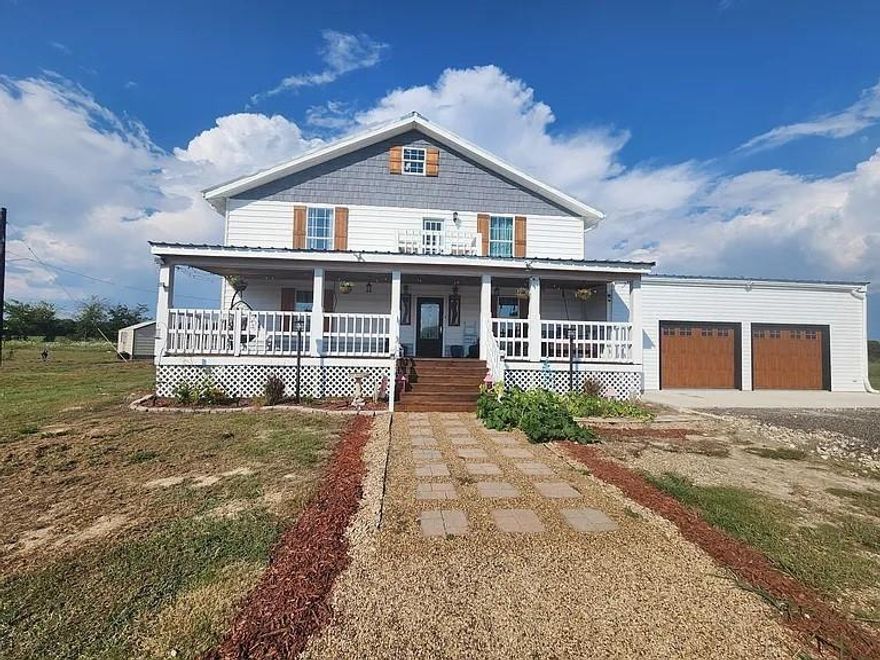 Modern Farmhouse No HOA The perfect blend of luxury, and country charm. Open-concept layout with soaring ceilings. Gourmet kitchen with massive island, double fridge, built-in microwave drawer, commercial-grade stove. Electric fireplace with real wood beam mantle and ceiling beam. Luxury primary suite and spa-like bathroom featuring a large stone walk-in shower, soaking tub, and double vanities. His & Hers custom walk-in closets. Oversized walk-in pantry. Mudroom and a full guest bathroom. Large landing, 4 additional spacious bedrooms two with en-suite baths and walk-in closets, private balcony. Large attic space with tall ceilings. Front deck: a bed swing, back deck is perfect for outdoor dining or entertaining. Attached 2-car garage with high ceilings. Detached garage-workshop, pond, fully fenced for livestock, additional electrical and sewer.