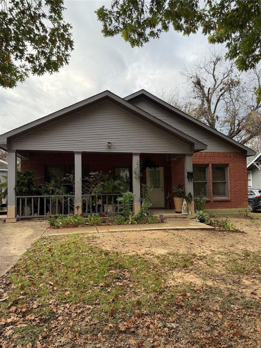 Charming Oak Cliff home just minutes from Bishop Arts! This well-kept 3 bedroom, 2 bath property offers a bright and open layout with plenty of natural light, wood-look floors, and a cozy brick fireplace that anchors the living space. The kitchen features granite countertops, white cabinetry, stainless steel appliances, and a breakfast bar that opens into the dining area. The spacious primary suite includes a large bathroom with a soaking tub, separate shower, and double sinks. Enjoy a generous backyard with room for outdoor gatherings, plus a long driveway with ample parking. Conveniently located near popular restaurants, shopping, and downtown Dallas, this home blends comfort, charm, and unbeatable location.