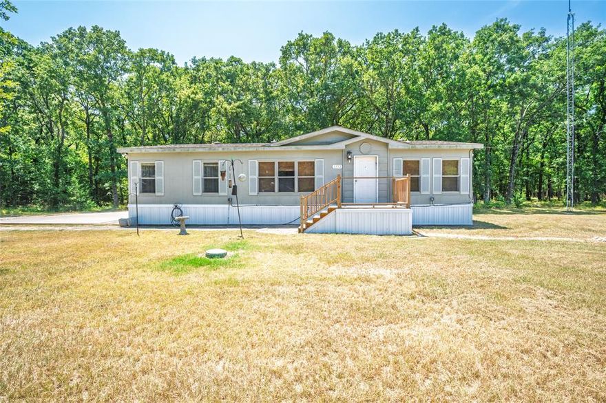 Owner financing available! The kind of quiet you can actually hear. 3 Bedroom, 2 Bath manufactured home on 3 ½ Wooded Acres Near Lake Tawakoni. Situated just minutes from the Lake , rare opportunity to combine space, privacy, and easy access to both nature and city conveniences. This home is set on a heavy-duty concrete block foundation with brand-new underpinning. Inside features include, open floor plan features a split bedroom layout, creating separation between the primary suite and the secondary bedrooms for added privacy. The property is rich with wildlife from deer and small mammals to an impressive variety of birds that frequent the trees and open areas. Evenings bring dark skies perfect for stargazing, free from the glare of city lights, and you’re just minutes from restaurants, shopping, and other everyday amenities. Best of both with city water and sewer in place and offers plenty of room for boat storage, RV parking, or off-road vehicles. The public boat launch is less than five minutes away, opening the door to over 37,000 acres of fishing, boating, and recreation on Lake Tawakoni. This is a geographically prime location less than 50 minutes east of Dallas, where a slower pace of life meets the convenience of being close to one of Texas’s largest lakes. The lake features multiple state parks with beach areas, camping, fishing and boating fun! Whether you’re seeking a weekend retreat, a full-time home, or a base for outdoor adventures, this property delivers nature, comfort, and accessibility in one unique package.