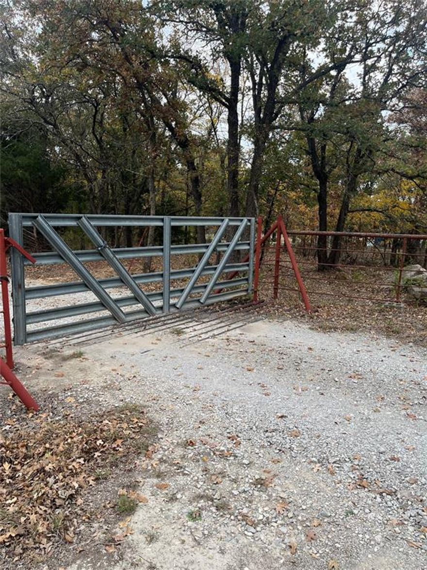 Beautiful 4.981 acre property with tons of trees.  Very secluded and private.   Great location to build your dream home.    Nice 4-2 doublewide with front deck in good condition.  Great location with easy access to 114 and downtown Boyd.  Would make investment property or    2nd mobile on property has no value.