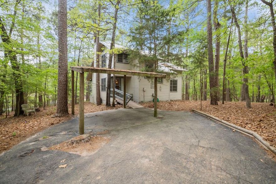 Adorable lake cabin with 3.026 acres in beautiful 4D Country Estates about 15 minutes south of downtown Winnsboro. The property sits on a heavily wooded lot with waterfront views of White Oak Lake and consists of two dwelling structures--a main house and studio efficiency apartment. Picturesque and infinitely relaxing, you will be among nature at its finest. The property was designed by a talented architect with clean, modern lines and super efficient floorplan. The main house is situated directly on the lake boasting 2 bedrooms and 1 full bathroom with 772 sq. ft. There is a primary bathroom on the first floor and second bedroom upstairs. The second dwelling unit is a studio efficiency apartment with approximately 327 sq.ft. and it sits right across the street still with lake views but not directly on the water. The main house is everything you envision for a lake property with laminate wood floors and solid pine tongue and groove walls along with tons of windows for breathtaking views of the lake. The studio efficiency offers a small open-concept kitchen off of the den area along with 1 full bathroom. There is plenty of room to accommodate both den and bedroom furniture in the open-concept space. 4D Country Estates is a fishing lake community offering 5 different lakes, a clubhouse, walking trails, boat ramps and a small public beach accessible to all residents. Fishing boats powered with troll motors are allowed but no water sports. Short-term rentals are NOT allowed and have been deed restricted for rentals less than 30 days at a time. This property is perfectly suitable for full-time living or used simply as a weekend getaway. The two dwelling units offer great flexibility to additional family or guests each with their own private space but still within close proximity.