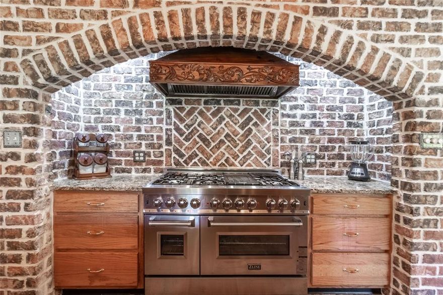 This waterfront home is nestled among stately oaks and pines on a gorgeous 26 acre lake.   Enjoy the spectacular lake views from the living room and large open patio.   Enjoy a fireplace with a heatolator for a cozy winter.   This unique property has three bedrooms and an extra family room that could be a fourth bedroom with a full bath. The kitchen has been beautifully updated in Tuscan style, featuring a brick arch over the commercial-grade 48-inch oven with  gas cooktop, griddle and grill.   It also features a double electric oven and custom vent-a-hood. The six-burner cooktop, granite countertops, and a farm sink make this a true chef's delight!  It is open to the oversized laundry room with ample storage for your extra cooking items.   The primary bedroom has a gorgeous view of the 191 foot shoreline.  Outside, you will find an air-conditioned workshop with a roll up door to bring the outside in.  A pump house is located near the water's edge for watering the yard.  The gazebo has electricity and water and would make a fun sleeping porch for the kids.  There is even a fenced in yard for the dogs.  Don't miss the 900 square foot guest house with a full bath and kitchen.  It has been rented in the past for $500 per month.  Come enjoy fishing, paddle boarding or just enjoy this tranquil setting.  Come make this your weekend getaway or full time home.