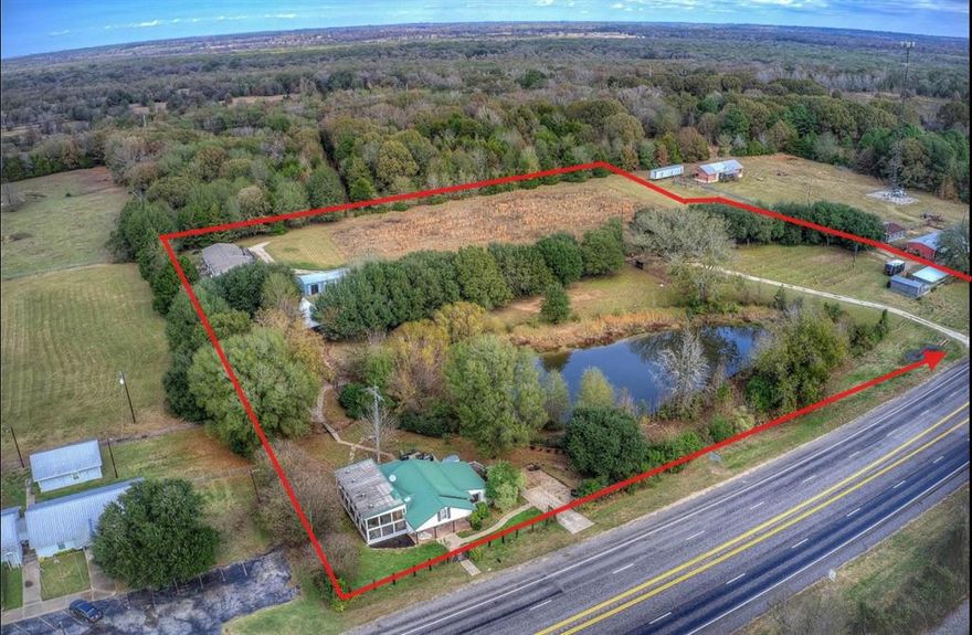 Discover a rare six-acre property in East Texas with a long, documented history and an incredible range of uses. Anchored by a 122-year-old farmhouse, this tract has served as a private homestead, a working vineyard, and most recently, a boutique winery with a full tasting room. Its layout, improvements, and utilities make it adaptable for residential, commercial, agricultural, or hospitality-based visions.

The property includes the original farmhouse, two guest cabins with baths, an 800 sq. ft. tasting room with kitchenette and half bath, an 800 sq. ft. workshop with an attached four-car carport, and a 2,280 sq. ft. manufactured home offering four bedrooms and two baths. Above-ground pool with decking & Pool cover.

A three-acre vineyard provides an Agricultural Exemption and once produced grapes for on-site wine production. A spring-fed pond sits near the center of the property—ideal for fishing or small-craft paddling. Acreage is level & open land for future development. A small, historic family cemetery is on the property as well. 

With its combination of structures, utilities, open space, and commercial history, this property can support multiple paths: a multi-generational compound, short-term rental cottages, a retreat center, RV park, agritourism venture, small-scale farming, or your own custom plan.

A truly flexible piece of East Texas land with the space, improvements, and history to move in a new direction—ready for its next chapter.