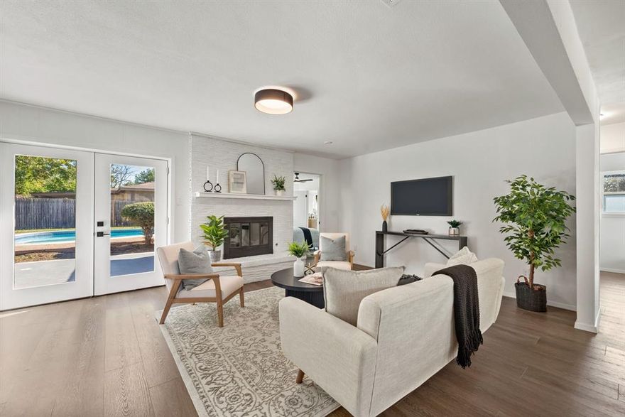 Welcome home! Step inside this fully renovated one-story home with a sparkling diving pool, perfectly situated on a spacious corner lot in the Continental neighborhood in Hurst, conveniently located within walking distance to North East Mall with a variety of shopping, dining and restaurants. Inside, the open-concept layout features luxury vinyl plank flooring throughout that seamlessly connects the living, dining and kitchen areas lined with new windows and light fixtures, creating a bright and inviting flow. The cozy living room highlights a brick fireplace with gas logs, ideal for relaxing or entertaining. This turnkey home offers three bedrooms and two beautifully updated bathrooms, including a spacious primary suite with dual sinks, a walk-in closet and views of the backyard. The galley kitchen showcases new countertops and updated appliances including a refrigerator that will stay with the home! Outside, enjoy your own backyard oasis with a diving pool and plenty of yard space to relax, making the perfect spot to unwind or entertain. Solar panels help keep energy costs down, while the new electrical and wiring throughout provides peace of mind. Don’t miss your chance to call this one home!