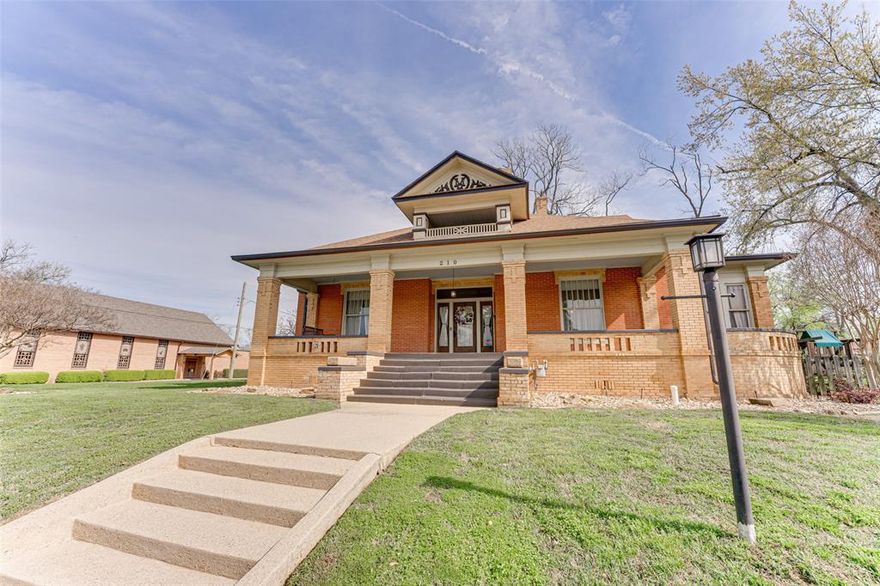 A rare opportunity to own a piece of history, this stunning 1913 home blends timeless character with endless potential! Rich in history and a focal point near downtown Winnsboro, this extraordinary 5-bed, 3.5-bath home spans 4,411 sq ft and offers a rare blend of historic elegance and modern updates. Two separate covered front porches each have their own entrance. Step inside the vestibule and into the rotunda to be captivated by the original Longleaf Pine floors, original grand mahogany pillars, and intricate staircase. The character of this home shines through with three original glass double doors, original light fixtures, functioning transom windows, and impressive 12-foot pressed tin ceilings. The main level features the primary suite with an oversized walk-in closet and a guest bedroom with an ensuite bath, both with fireplaces. Upstairs, you’ll find three additional bedrooms and a fully remodeled bath with a clawfoot tub. Two of the upstairs guest rooms have walk-out balconies, and one showcases beautiful original shiplap from top to bottom. This home has been thoughtfully upgraded for modern comfort, featuring a tankless water heater, foam insulation, a completely updated plumbing system from the house to the street, and upgraded electrical panels relocated to the basement. A 50-year shingle roof was installed in 2017, along with a sprinkler system and paid-off solar panels for energy efficiency. Additional highlights include zoned HVAC with four units, two spacious attics with floored storage space, and a basement with exterior access. Outside, enjoy the huge, fenced yard, mature trees, and a spacious covered patio with an outdoor kitchen and gas fireplace. There is a large recreation room complete with a bar, in addition to the carriage house that is two-cars deep. This is a one-of-a-kind opportunity to own a piece of history—updated for modern living! Special financing on this home-reach out for more info.