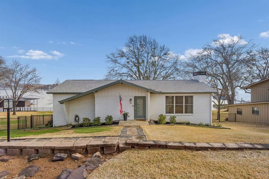 If you've been looking for an affordable, turn-key lake house in one of the most desirable communities on Cedar Creek Lake, here's your chance! 25 Shoreline Drive is an adorable 3-bedroom, 3-bathroom home in Star Harbor, perfectly situated on the south end of the lake offering deep water and gorgeous main lake views. Thoughtful designed for both everyday living and weekends on the lake. Main level features an inviting open-concept kitchen and living area, complimented by an updated kitchen with huge island and original brick fireplace in living room. Also on the first floor, you’ll find a spacious primary suite with private bath, along with an additional guest bedroom and full bathroom, offering convenience and flexibility for visitors. The lower level expands the home’s functionality with a third bedroom, full bathroom, laundry room, and abundant storage space — ideal for hosting extended guests or creating a private guest retreat. Step outside and experience what truly sets this property apart. A newly added covered back porch (2025) provides the perfect place to unwind, entertain, or simply enjoy the shade after a long day in the sun. Just beyond, a newly built one-stall boathouse features automatic lifts and covers, making lake access effortless and protecting your investment year-round. High desirable Star Harbor community features a 9 hole golf course, deep water boat launch, and a great mix of full time residents or weekenders! This area of the lake is known for some of the deepest water and preferred for boating, surfing, and float fun! Short-term rental friendly. Whether you're seeking a weekend getaway or a full-time waterfront lifestyle, 25 Shoreline Drive delivers the ultimate lake experience.